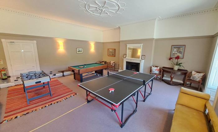 This large ground floor room is shown set up, ready for a family and friends gathering to have some fun. The games tables can all be put for conferenc